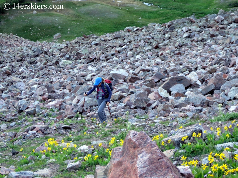 Natalia Moran climbing talus to ascend Snow Peak. 