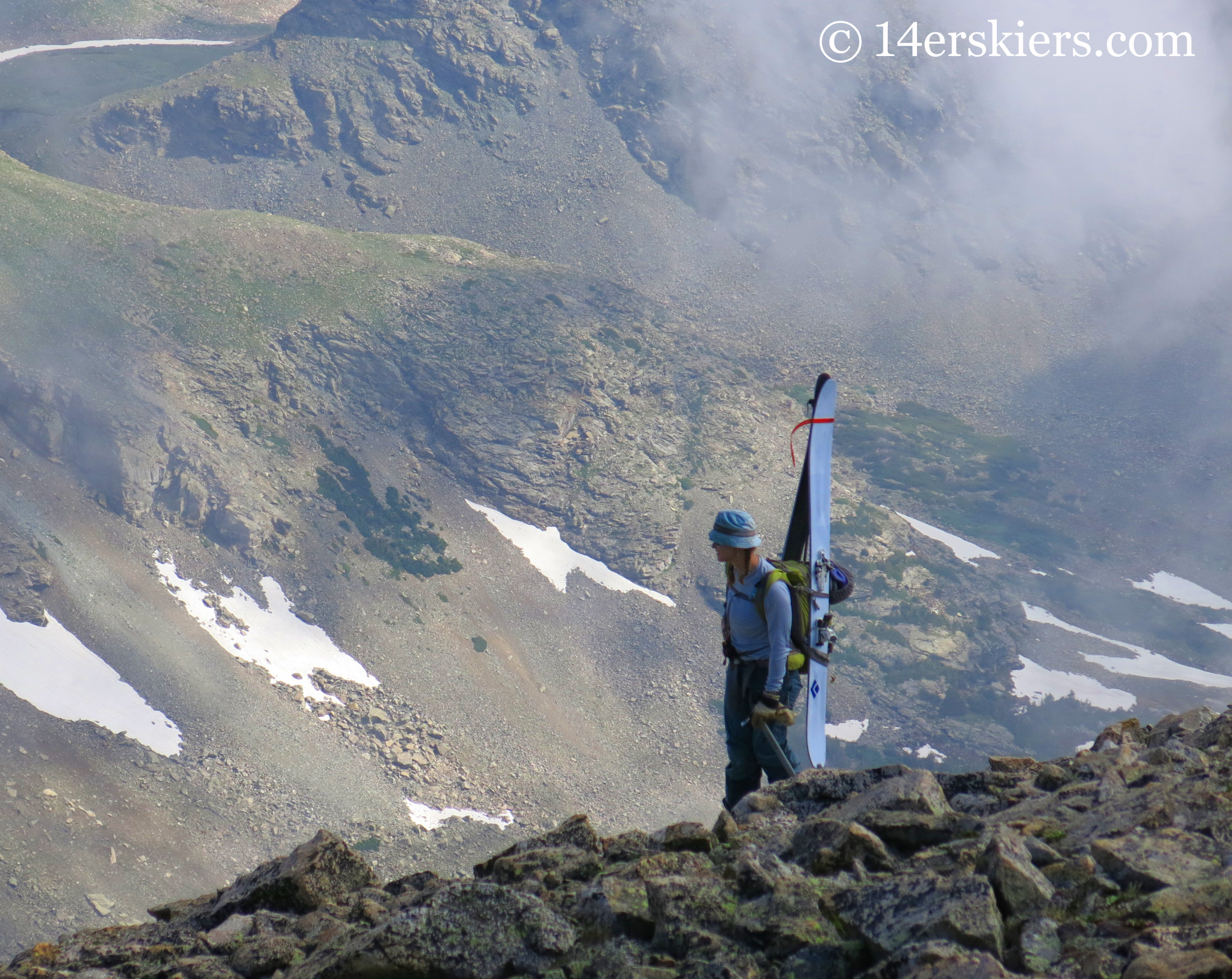 Brittany Konsella checking out alternate lines on Mount Audubon with Carbon Megawatts on her back.