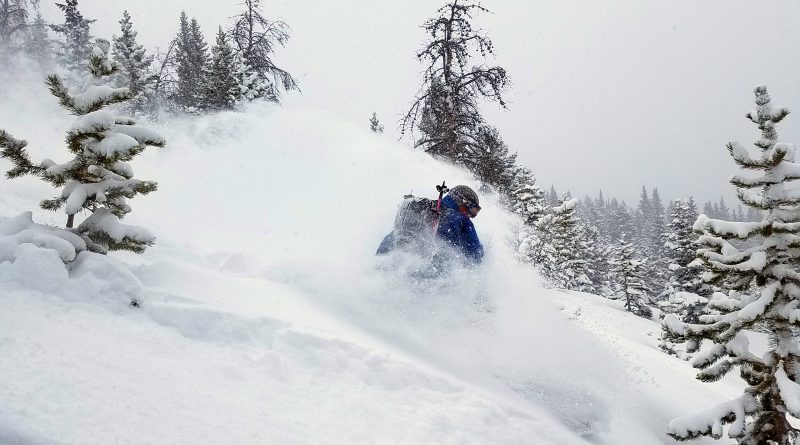 Backcountry snowboarding on a powder day.